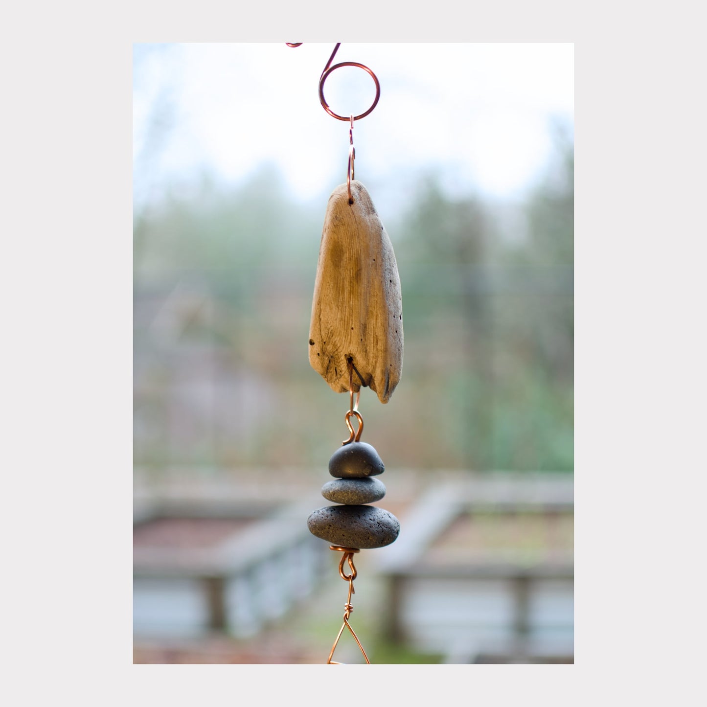 detail, driftwood and beach stone wind chime