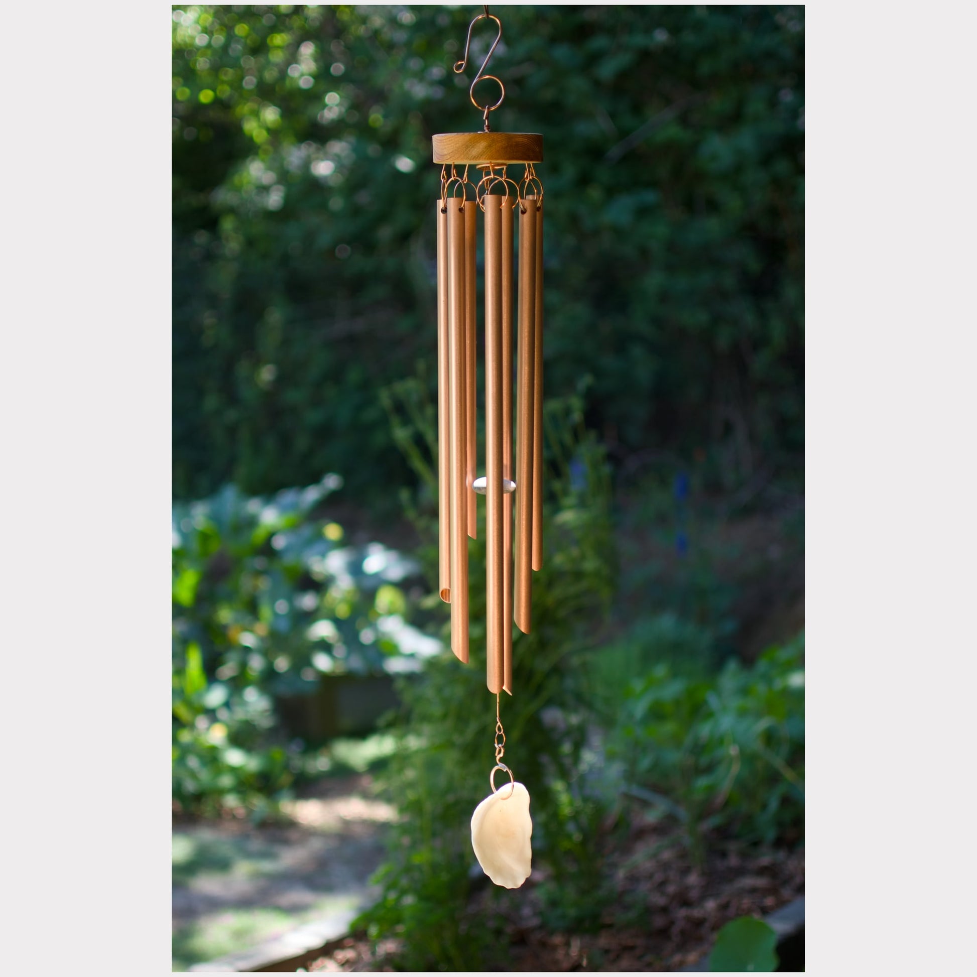 Handmade wind chime featuring 7 genuine copper chimes and an oyster half shell windsail.