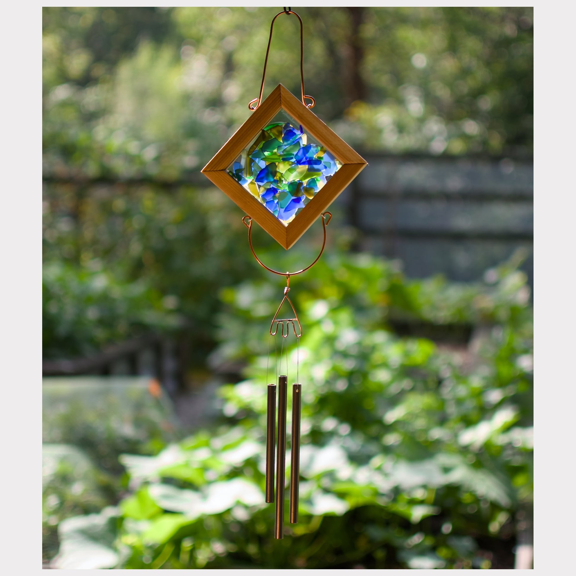 Sea glass kaleidoscope wind chime with three brass chimes.