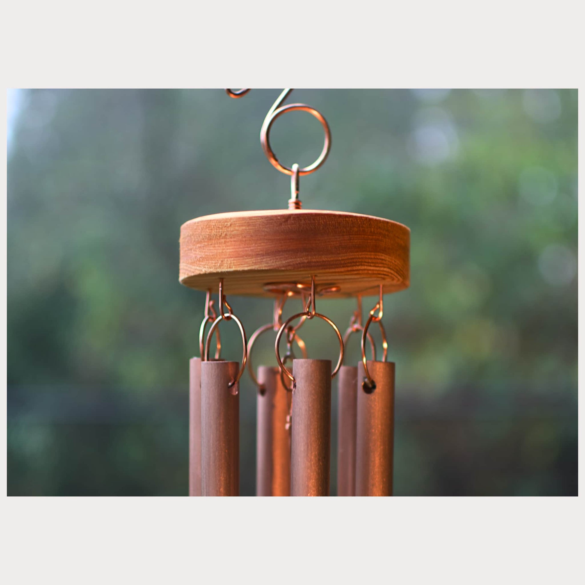 Zoom detail of a handmade copper wind chime with handcrafted copper hardware.