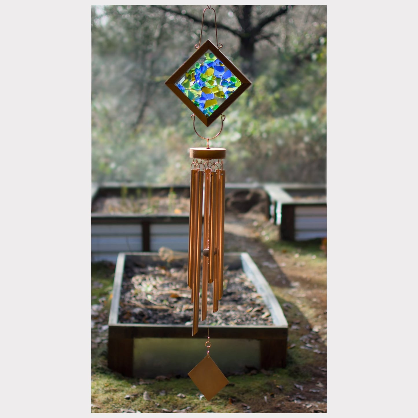 Large kaleidoscope wind chime featuring artist-made sea glass and seven genuine copper chimes.