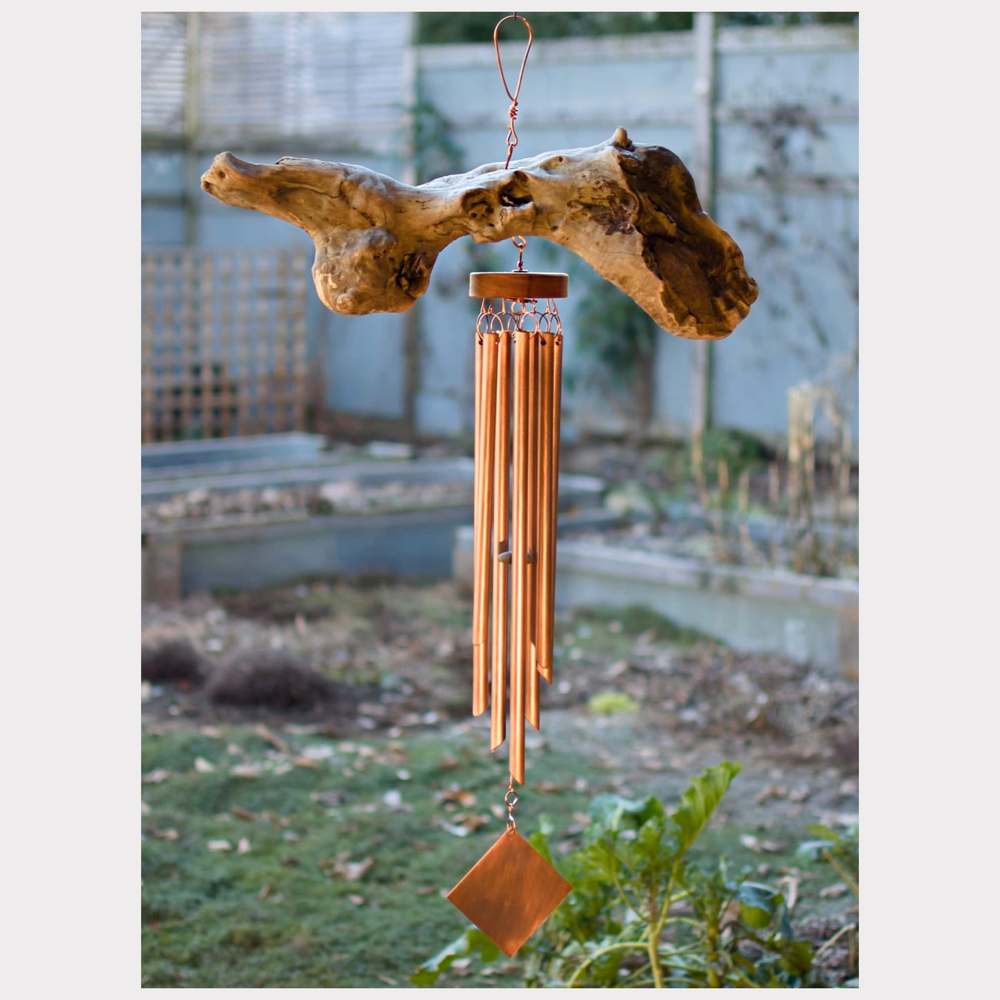 Large driftwood wind chime with seven copper chimes.